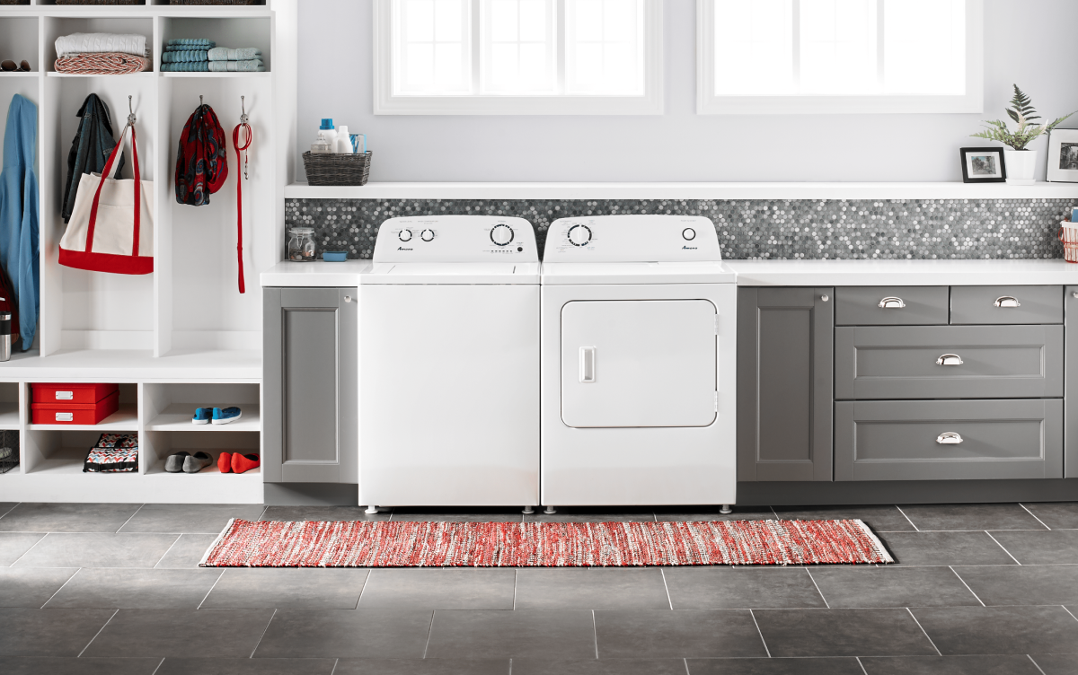 A white Amana® washer and dryer in grey cabinetry