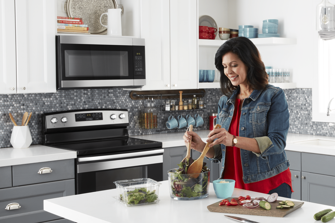  Woman making salad in a modern kitchen