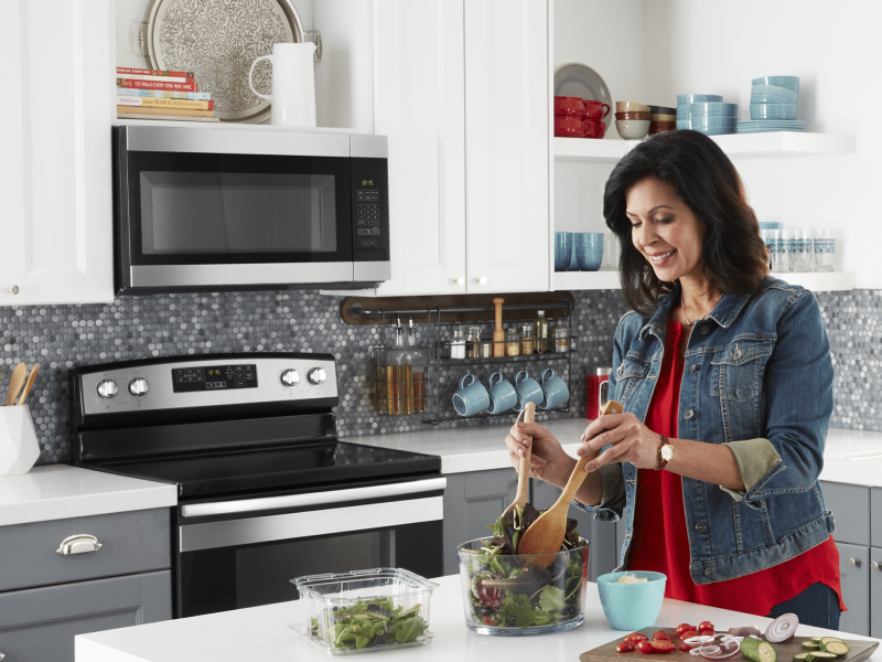 Woman making salad in a modern kitchen